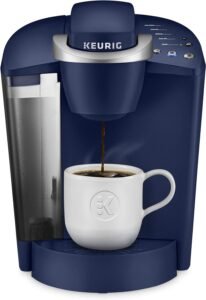 The coffee maker is compact and sleek in design, with buttons and indicators for brewing options. It can brew coffee in 6 to 10 oz servings, providing convenient single-serve coffee brewing at home or in the office."