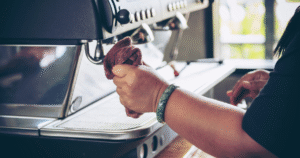 "Wiping electric coffee maker with damp cloth"
