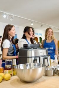  Photos of people using Philips machines at home, in kitchens, or enjoying coffee.