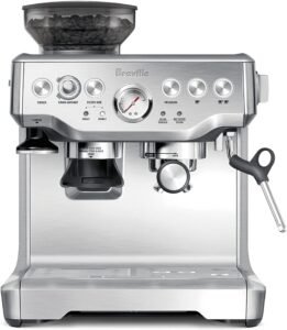 "A brushed stainless steel espresso machine with integrated grinder. It includes a steam wand for milk frothing and a control panel with manual and programmable settings."