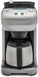 "A brushed stainless steel coffee machine with built-in grinder. Features customizable grind settings and brew strength options, displayed on an LCD screen."