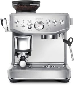 "A brushed stainless steel espresso machine with integrated grinder. It features a steam wand for milk frothing and a control panel with manual and programmable settings."