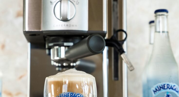 Espresso maker with milk having a cup filled with coffee.