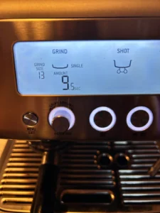 User adjusting grind size on Breville Barista Pro espresso machine