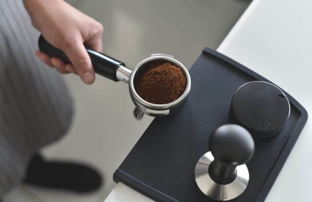 Fresh coffee being served from a thermal carafe drip coffee maker.