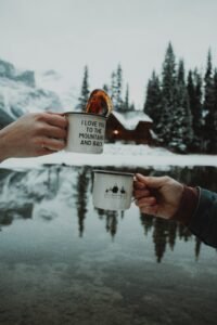 image of two hands holding a cup standing opposite each other.