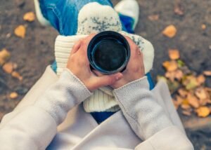 image of a hand carrying a cup of coffee 