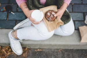 Image of a person taking a lunch with a donut and barista.