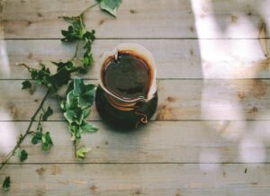 A cup of coffee placed on the wooden bench. 